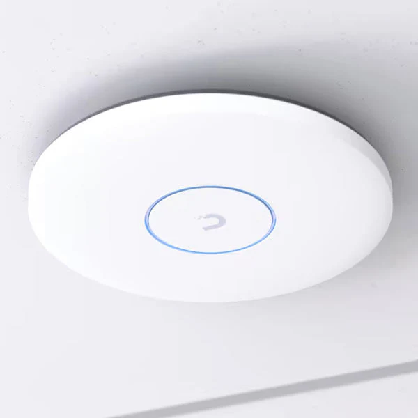 A Ubiquiti UniFi access point on the ceiling